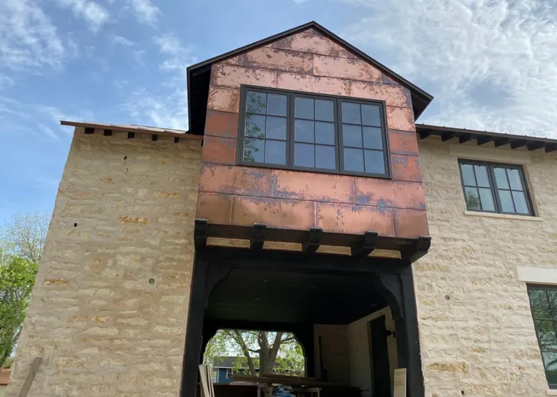 Copper metal panel facade on a stone building for Skylight Installation in Kuna