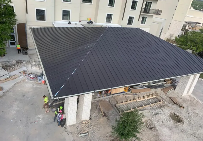 Metal roofing installation team working on a commercial building in Kuna