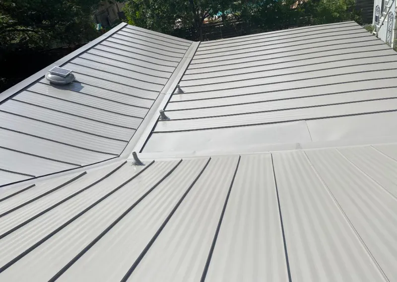 Solar attic fan installed on a metal roof for Roof Ventilation in Kuna
